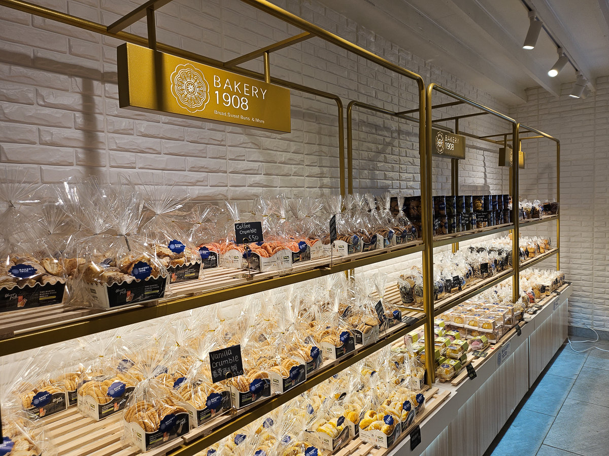 gold metal and white shelves with prepackages baked goods